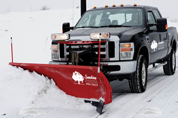 Sunshine Maintenance and Landscaping Plowing Snow on a Winnipeg Driveway