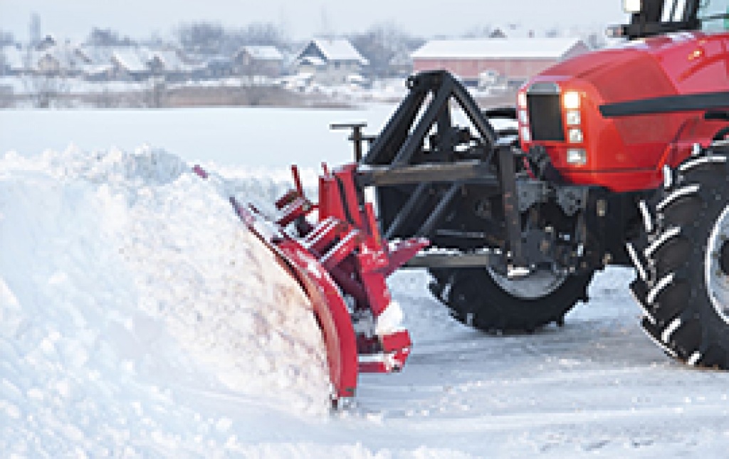 Winnipeg Snow Removal Experts: Sunshine Maintenance & Landscaping plowing residential snow from driveway